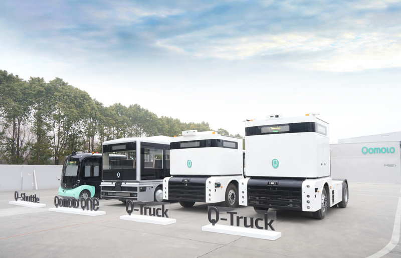 Autonomous electric vehicles including Q-Truck and Q-Shuttle displayed outdoors for smart logistics transportation solutions.