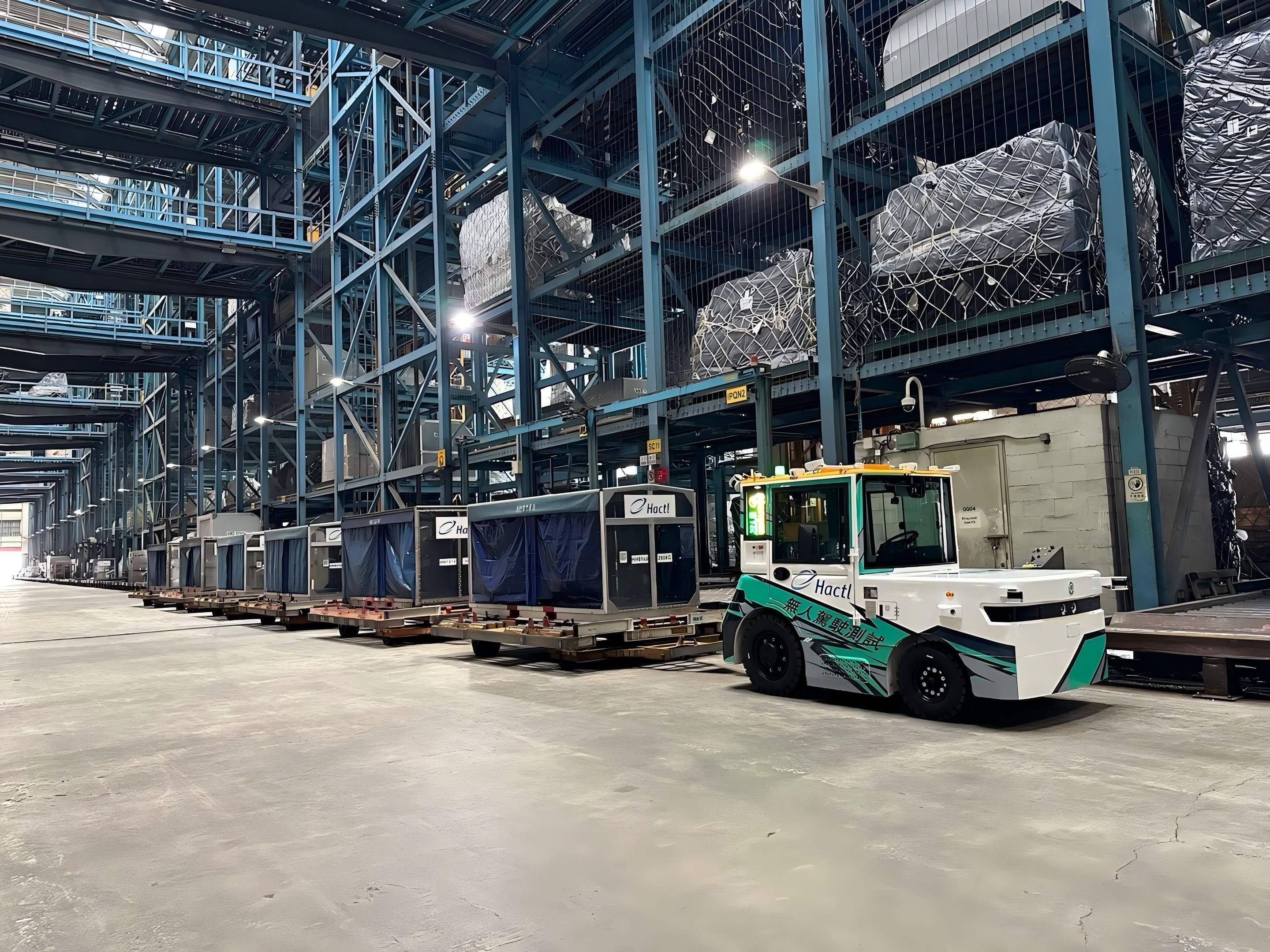 Westwell cargo tractors towing pallets at Hong Kong Air Cargo Terminals Limited (Hactl) to perform repetitive transport tasks and ensure seamless cargo flow.