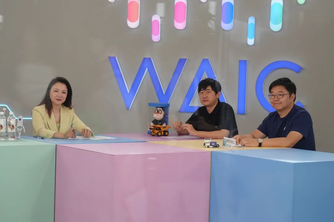 Westwell team members participating in a discussion or interview at a modern office studio with technology branding.