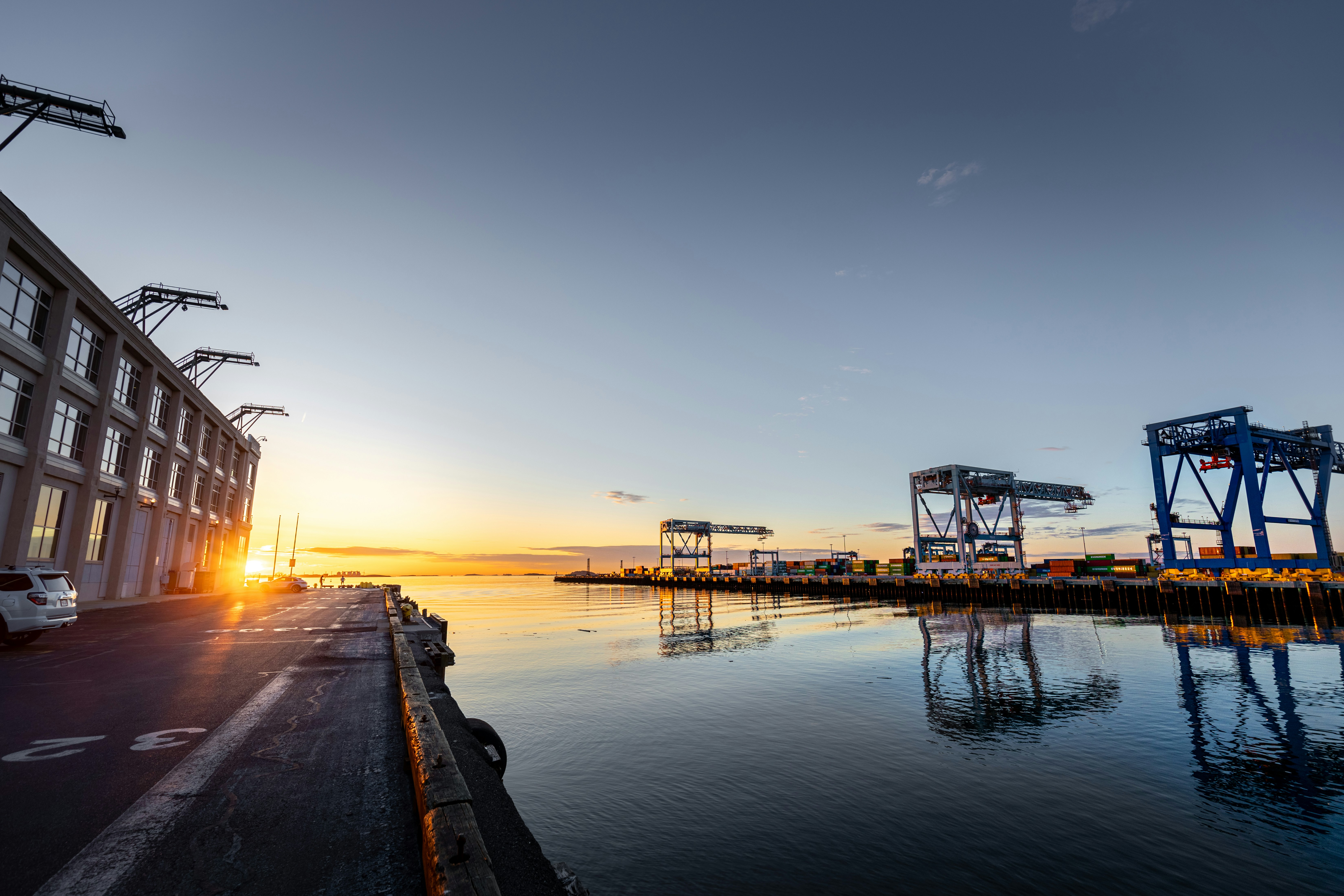 Sunrise view over modern ports and container terminals, symbolizing a brighter future for global port operations, automation, and smart ports in 2026.