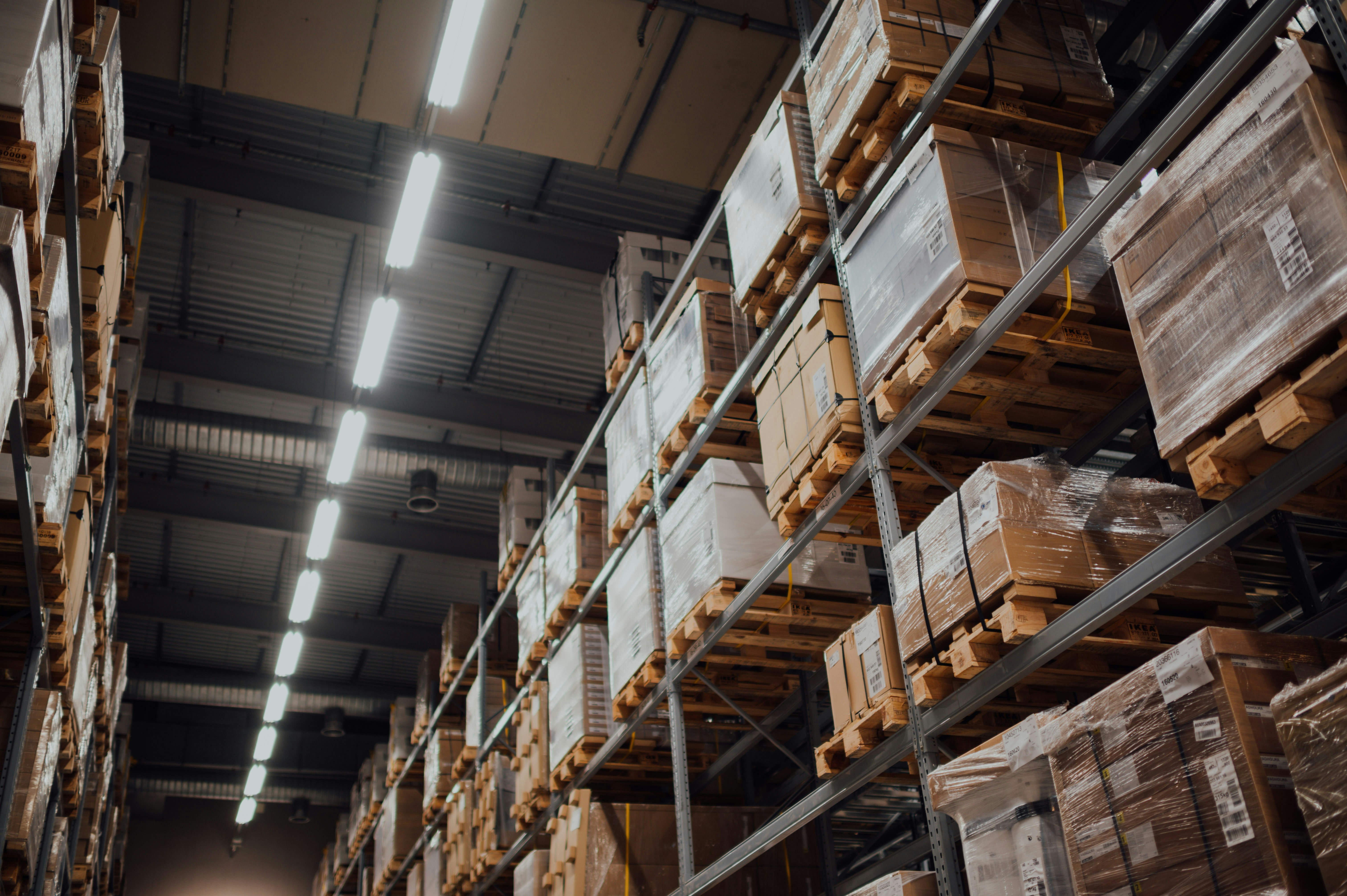Upward view of a warehouse with neatly stacked goods, illustrating organized and efficient logistics operations