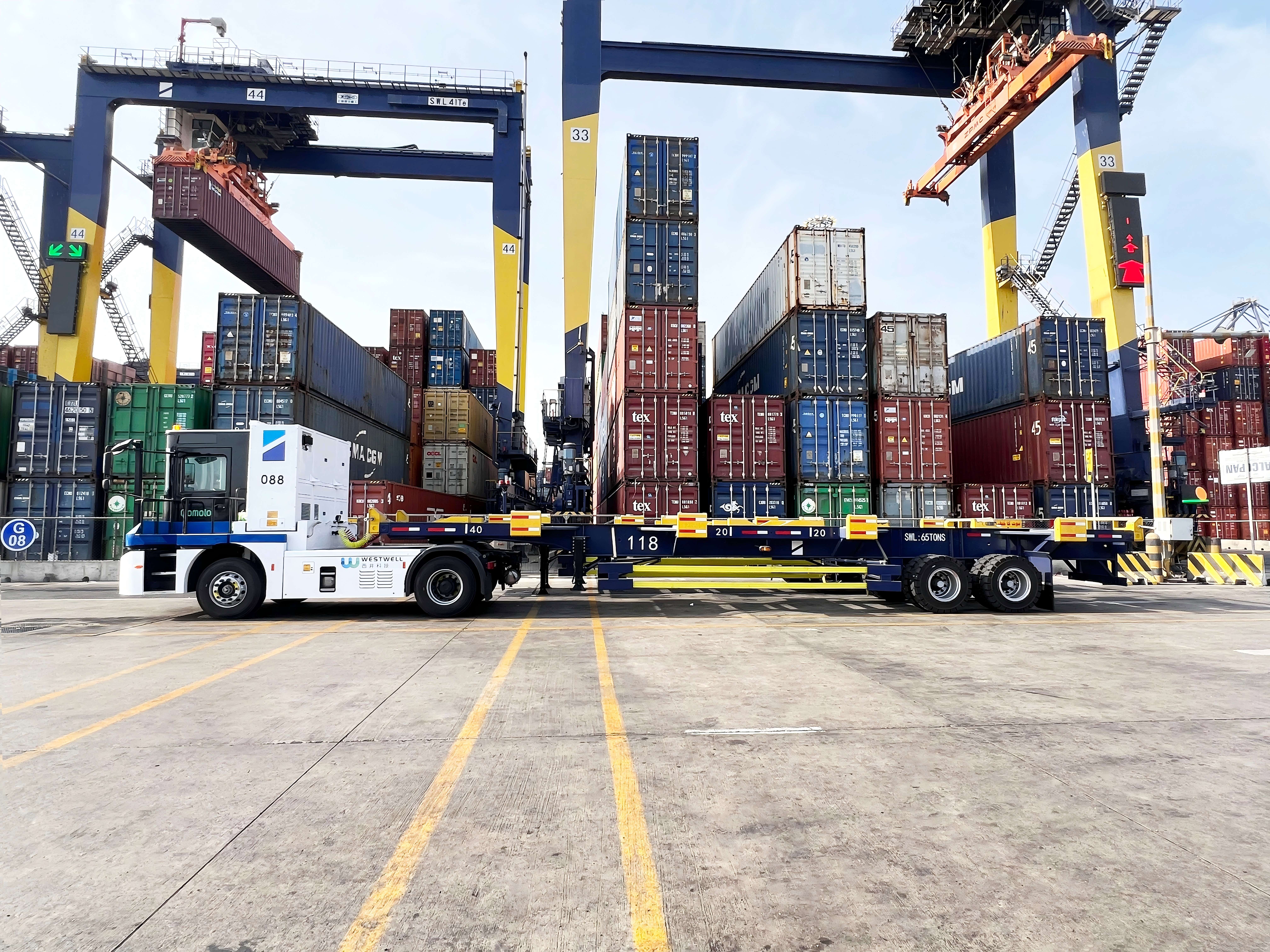 Westwell E-Truck electric yard tractor in a container yard preparing for a transport task.